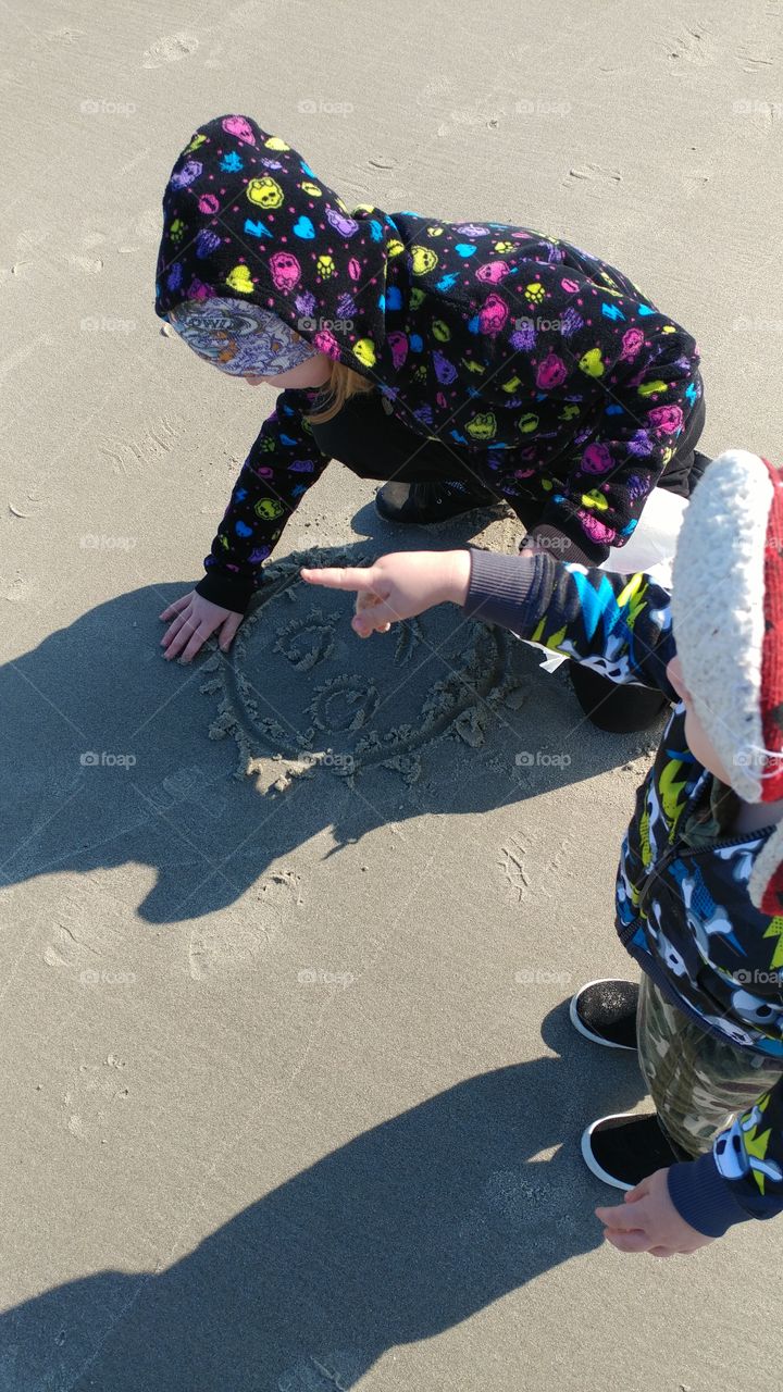 So much love here... my granddaughter was trying to show her little brother how to draw in the sand but...he couldn't take his eyes off of the OCEAN!😄