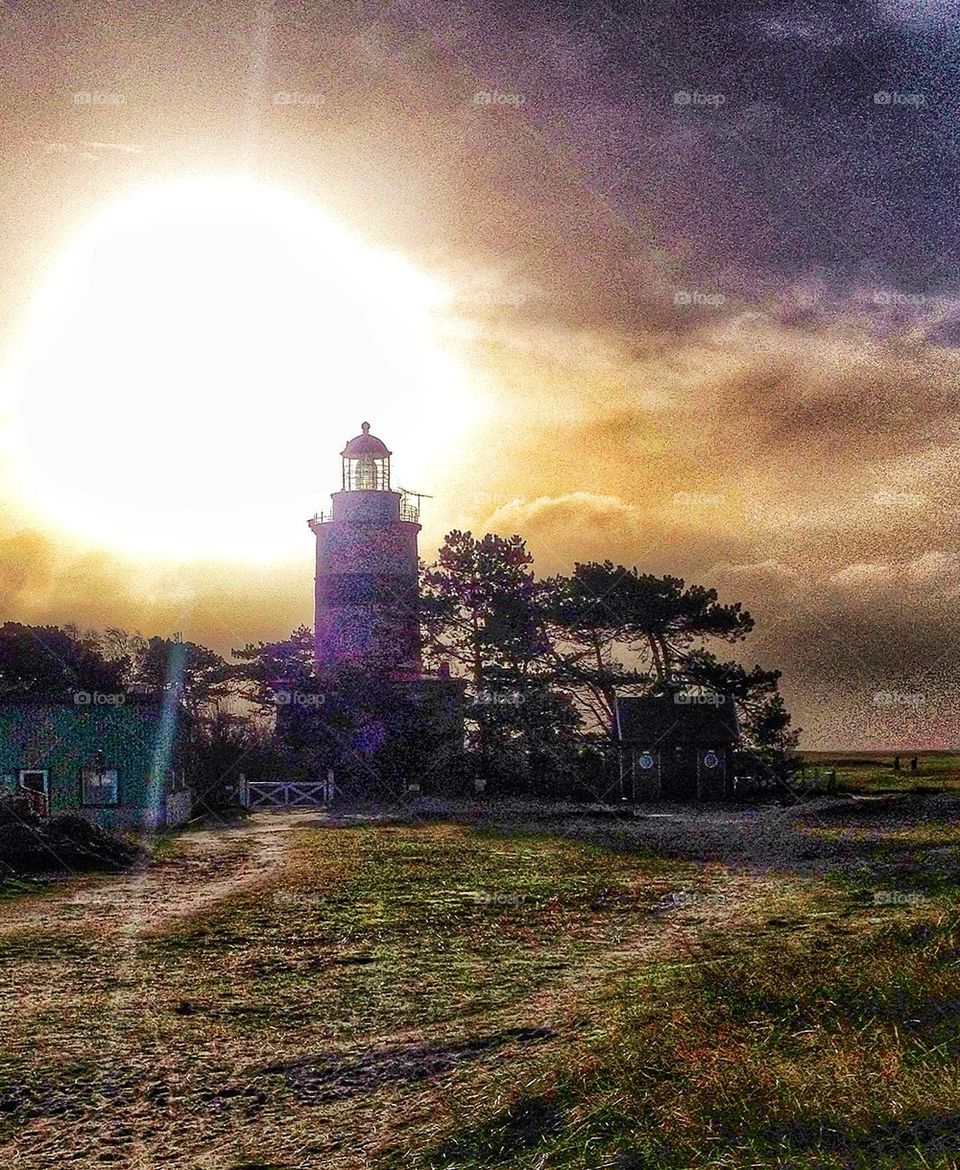 Lighthouse in sun rays