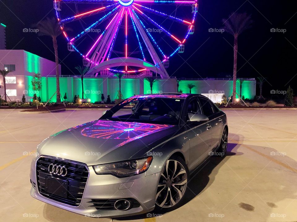 
Cars with soul - 2014 Audi A6 4dr Sdn quattro 3.0L TDI Premium Plus with a reflection from a colorful Ferris Wheel 