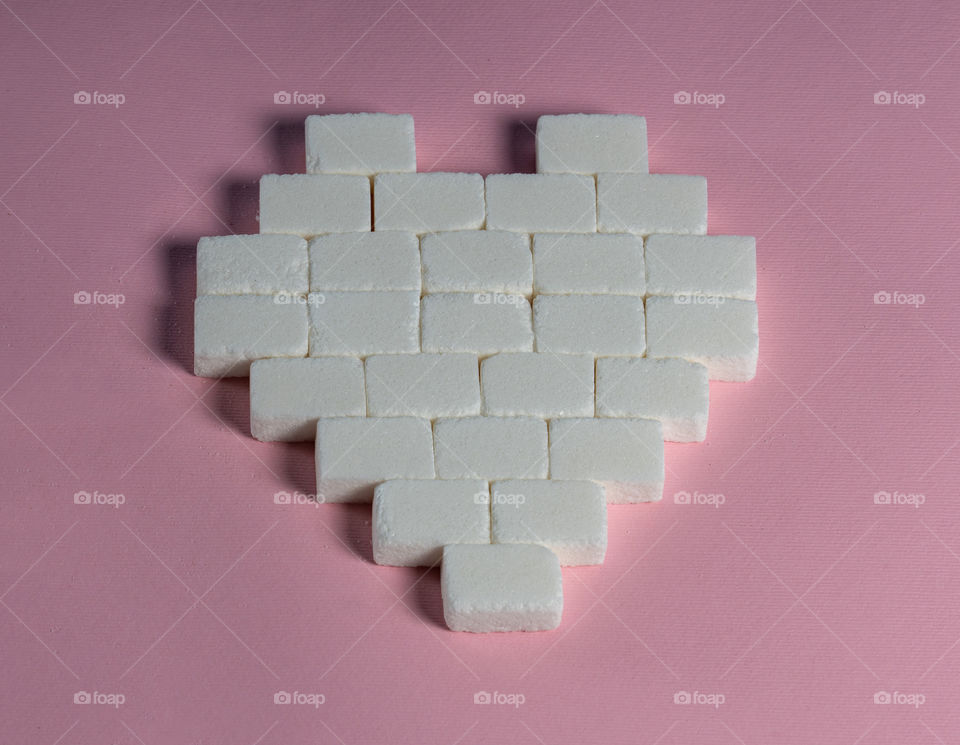 Sugar cubes in heart shape. Creative valentine concept