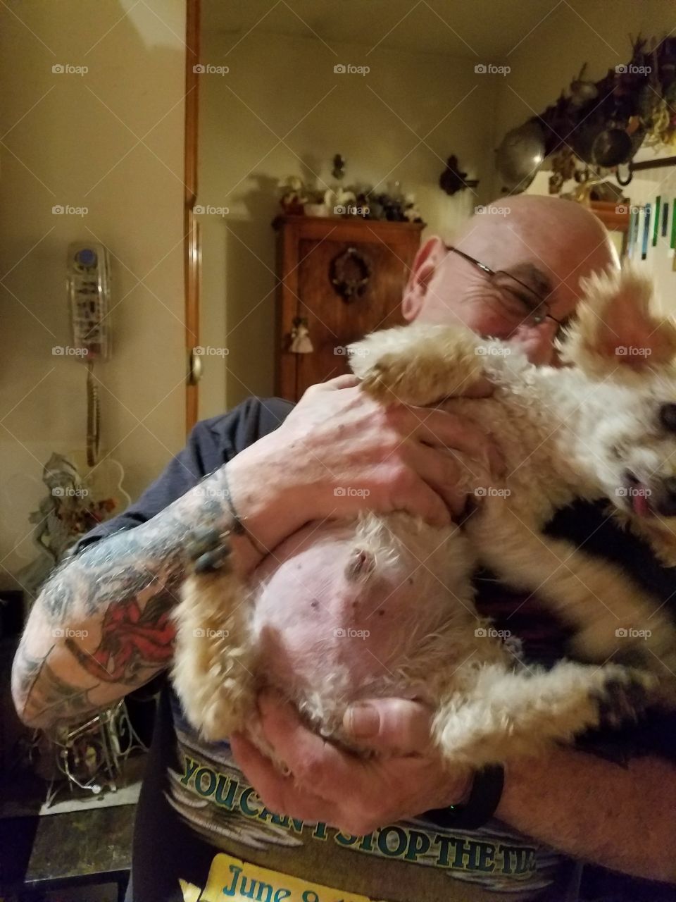 Struggling with dog to take pic together with owner.