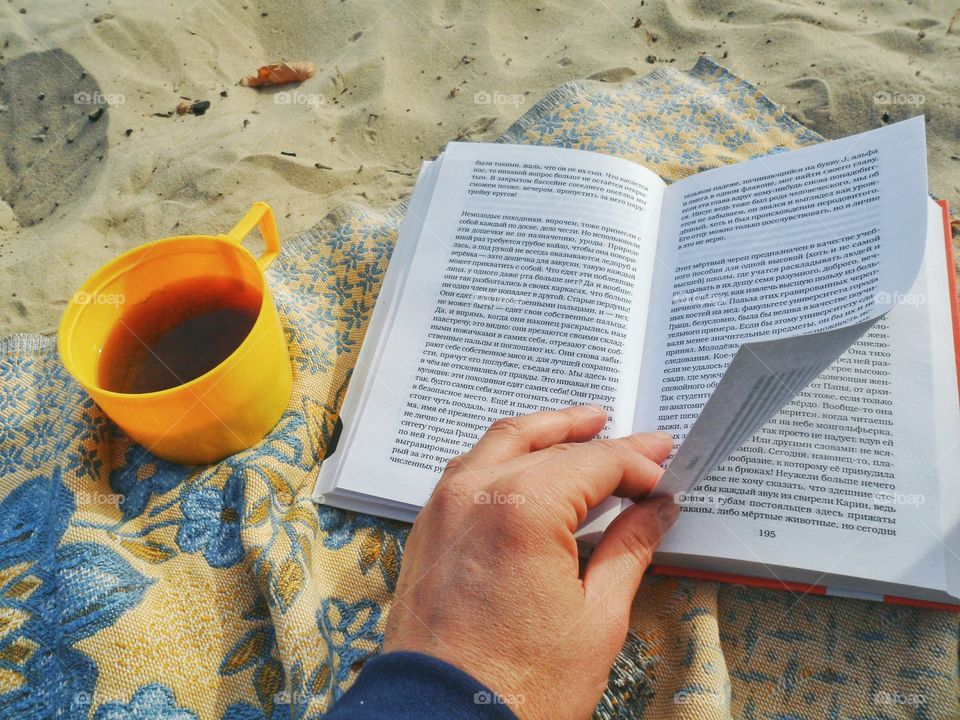 Hand leafing through a book