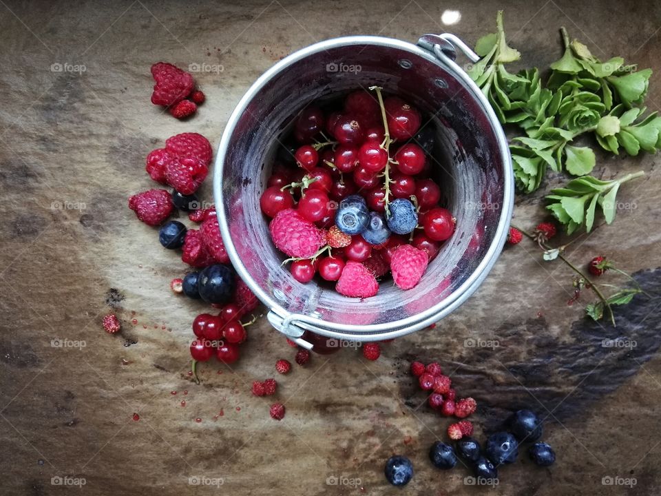 Different berries in metal bucket