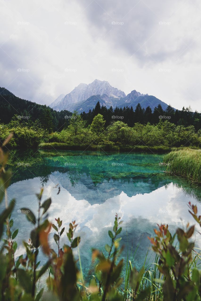 Mountains and clouds reflection in crystal clear lake