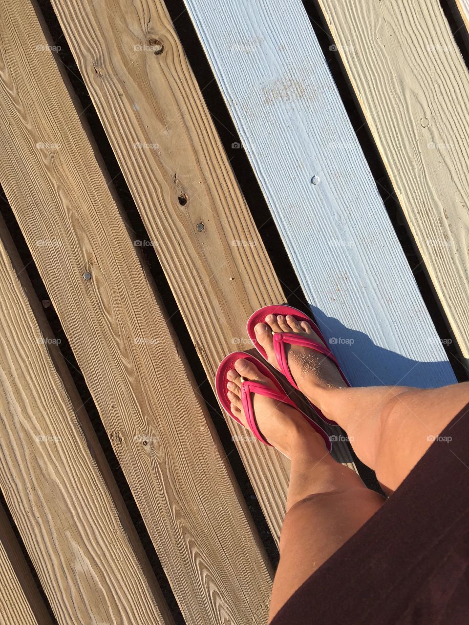 Low section of woman standing on wood