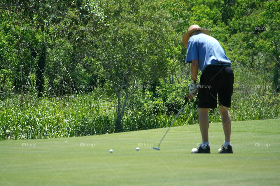 Man playing golf Quail Creek golf course Fairhope Alabama