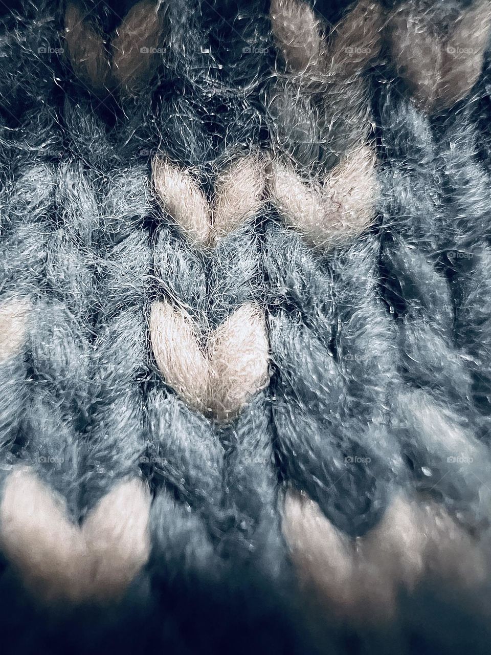 Fabric pattern on a crocheted winter hat in blue and white.