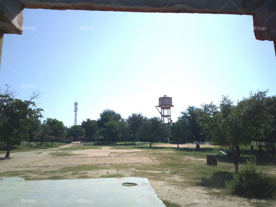 on contrast overhead   water tank and mobile tower
