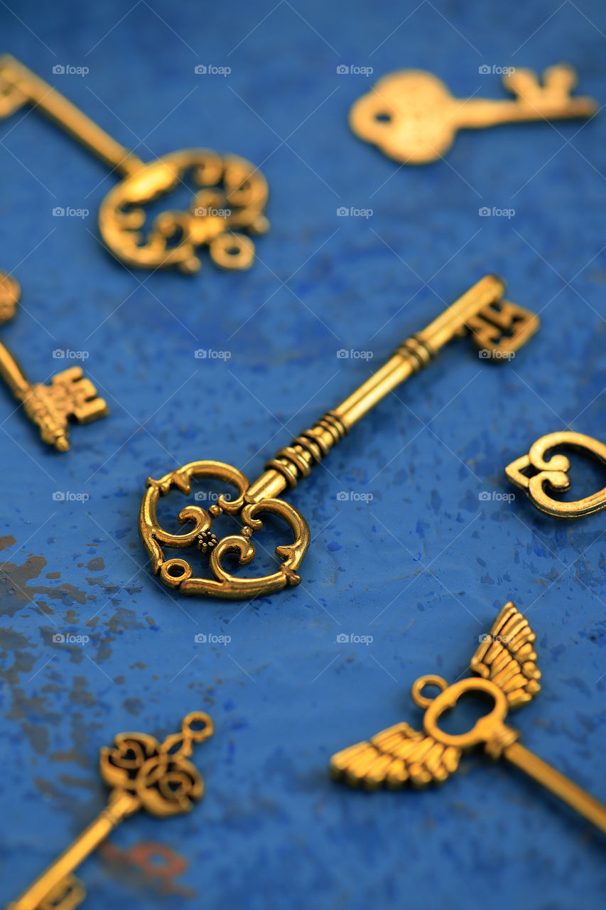 antique golden key on dark blue textured background