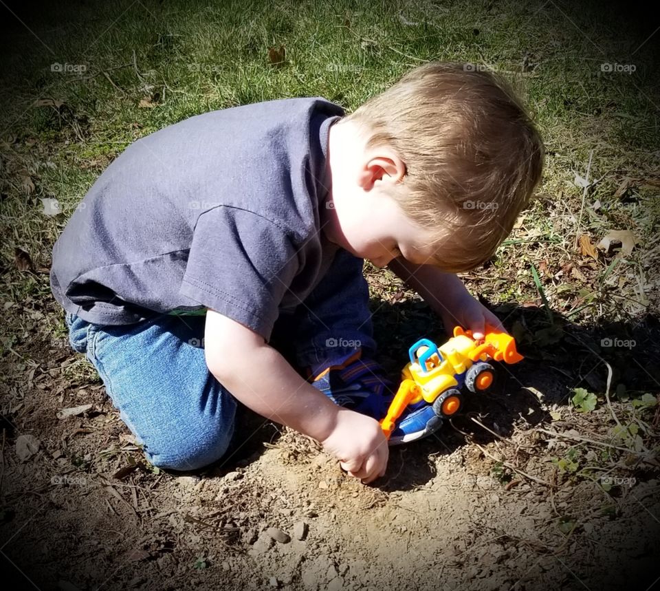 A Boy At Dirt Play