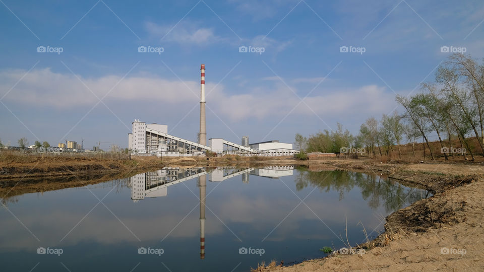 the factory near the lake in spring
