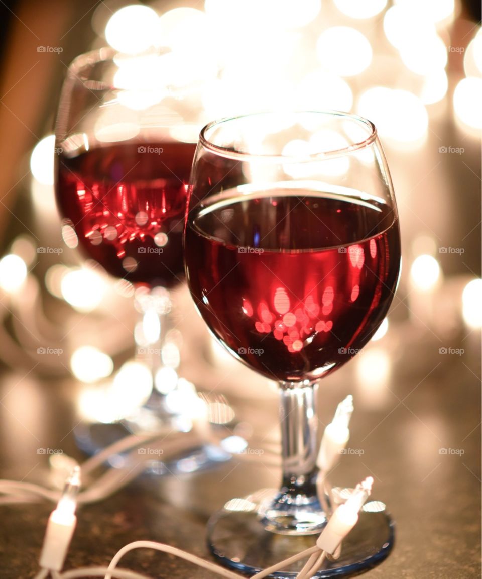 Beautiful rich red colored wine. Lights reflecting off crystal clear glasses. Would make an excellent display piece, possibly even a gift for a wine lover! 