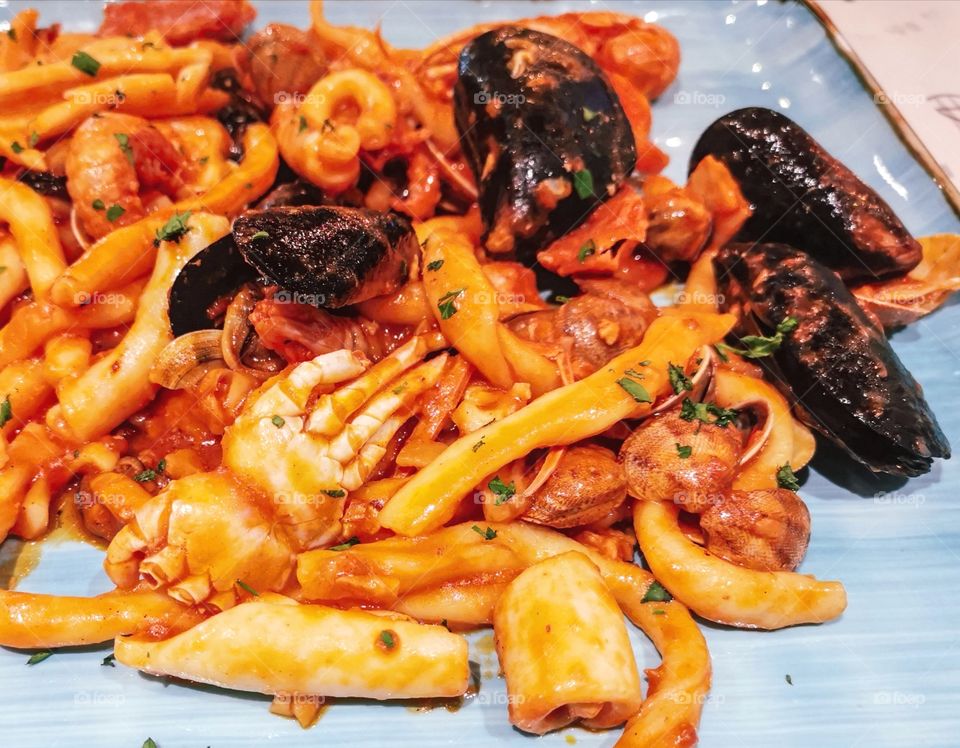 Italian pasta seafood with tomato sauce.