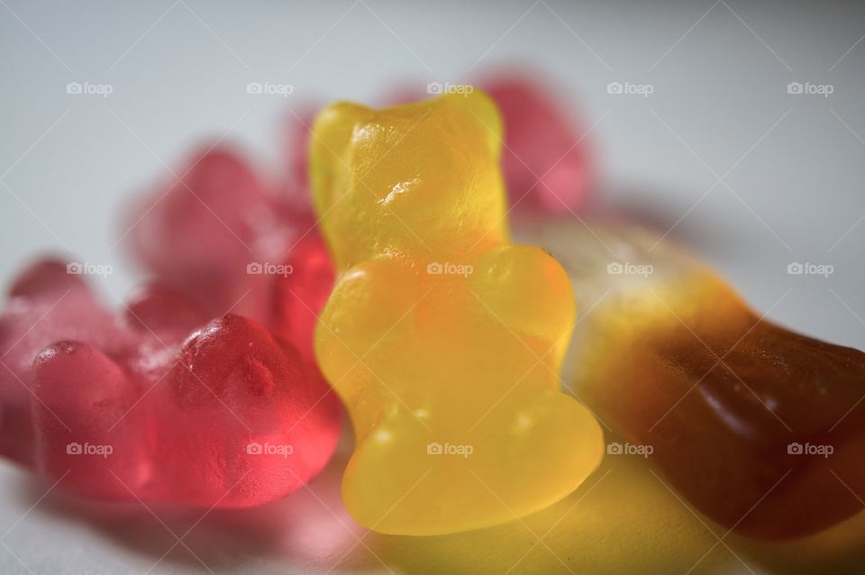Close-up of candy: gummy bears and a cola bottle 