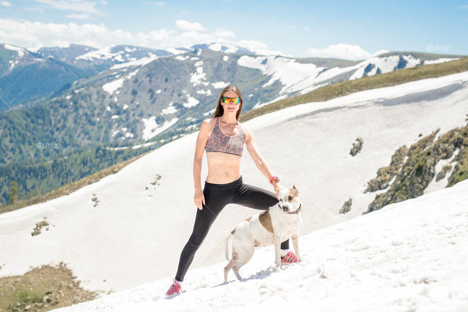 woman with a dog in the snow in summer