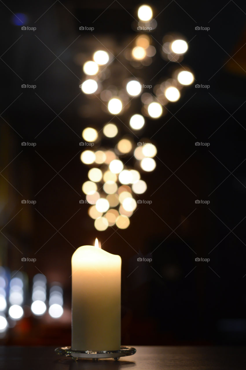 one candle with beautiful expressive light reflections