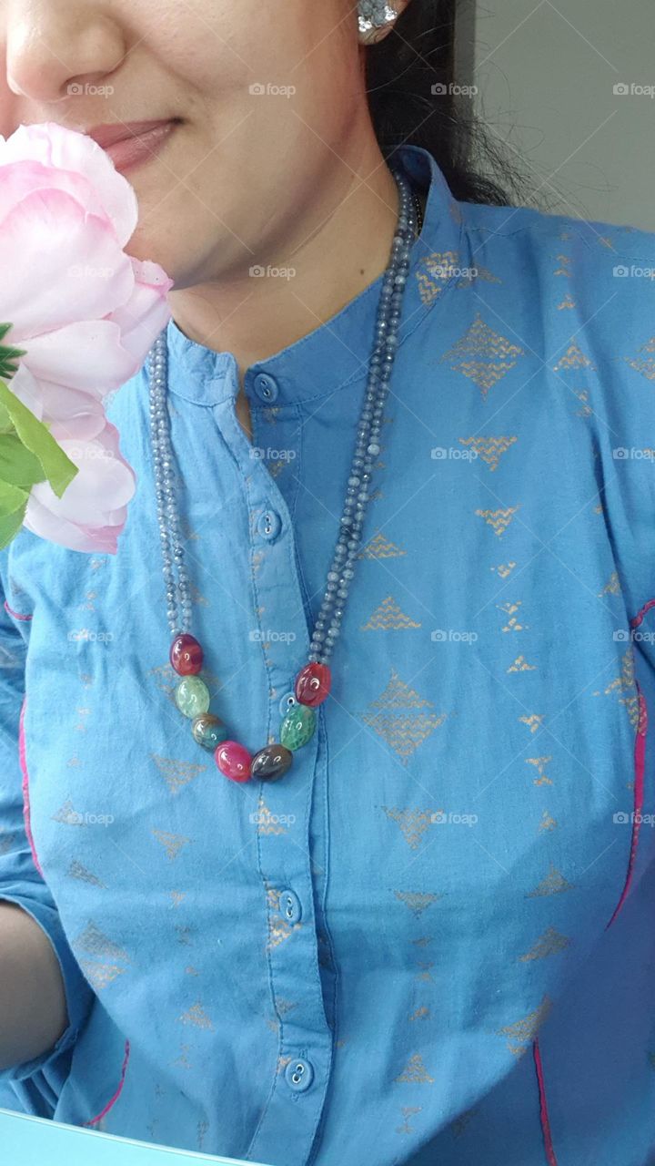 women with colourful beads chain on her neck and ear rings