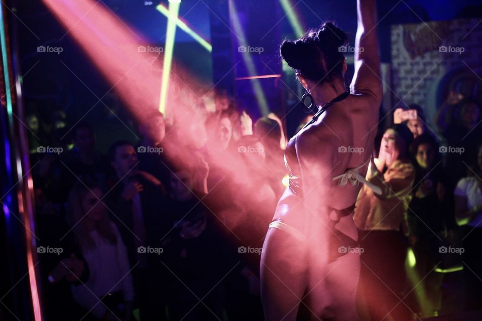 Dancing girl in the lights of night club