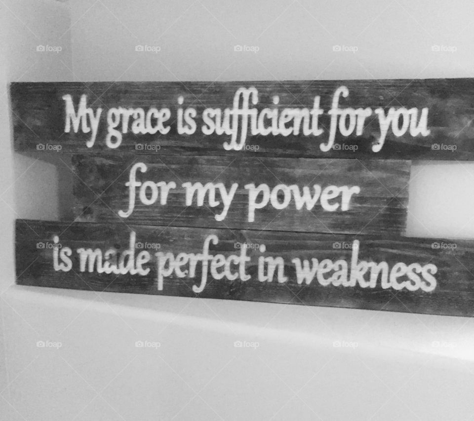 Wooden sign with scripture on it.