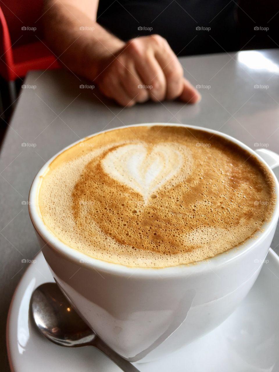 Valentine's Day love heart shape in white cream foam of Cafe latte coffee 