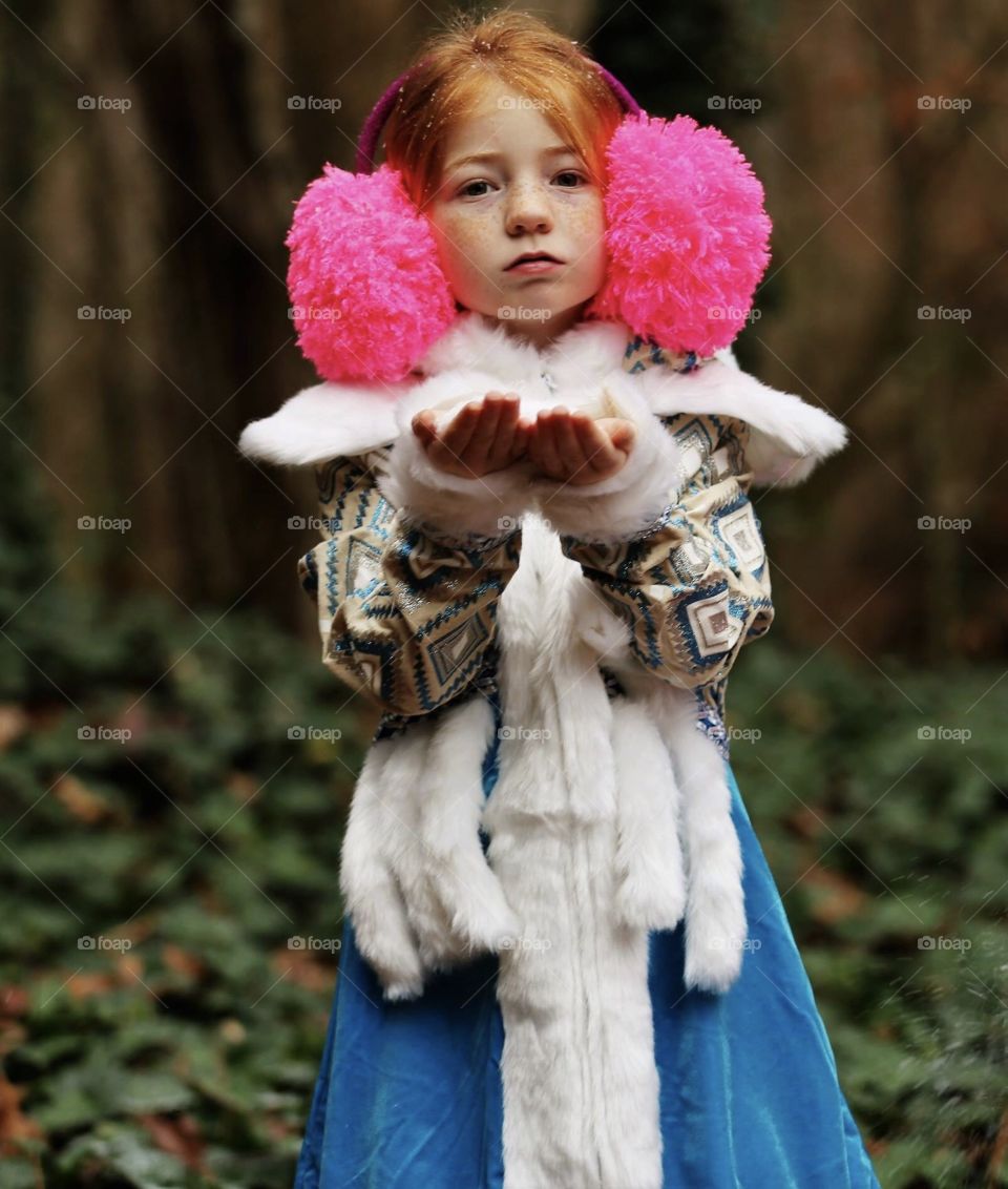 Portrait of little girl in fur jacket