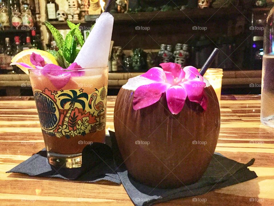 Tropical drinks on a bamboo bar in a tiki bar