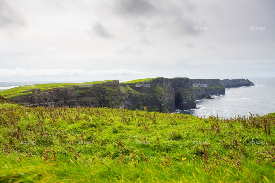 Scenic sight at the must see tourist attraction in Ireland. The Cliffs of Moher are sea cliffs at the edge of the Burren region in County Clare, Ireland. They run for about 14 kilometres.