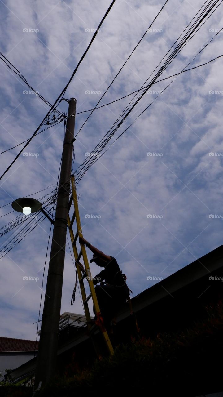 Human interest - A worker is repairing a street light