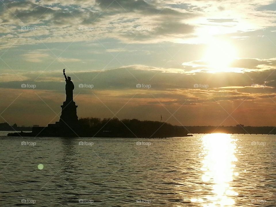 Statute of Liberty at dusk from a ferry on the New York Harbor