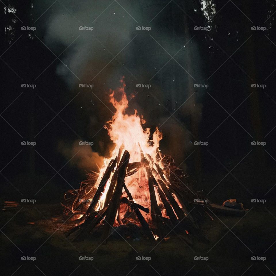 A controlled bonfire next to the woods