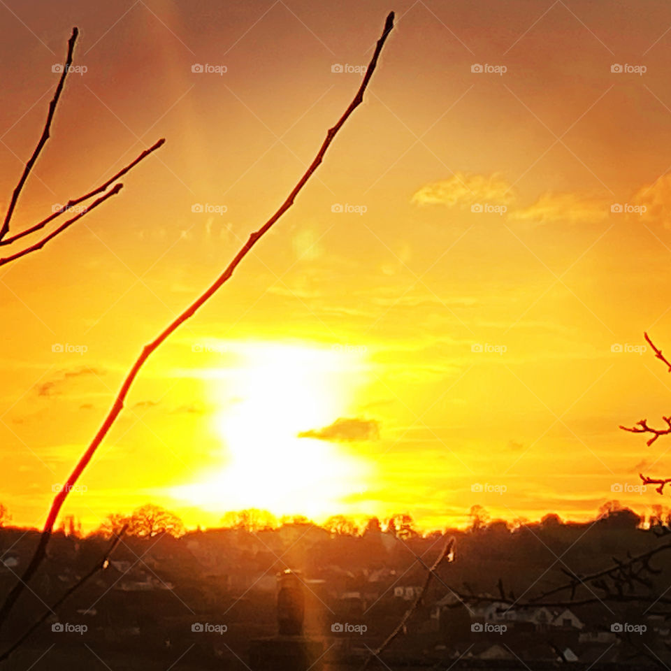 The Sky is Aligned with A Yellow Ball Of Flame, that sets the sky a blaze, that resembles an exciting “light show.”