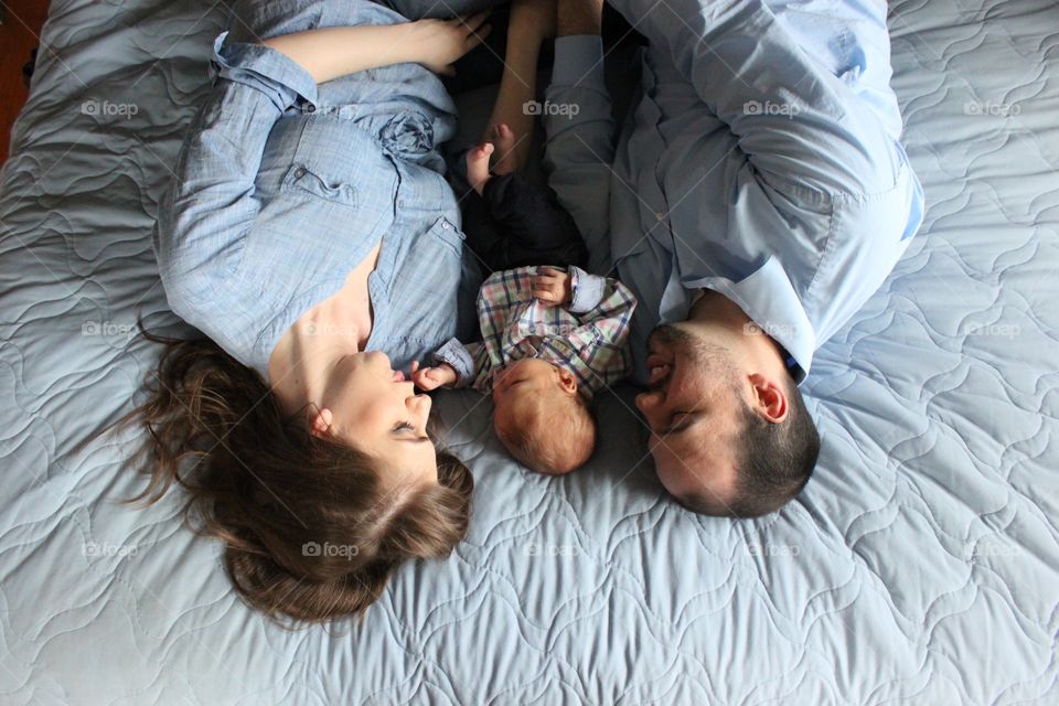 Happy family lying in bed