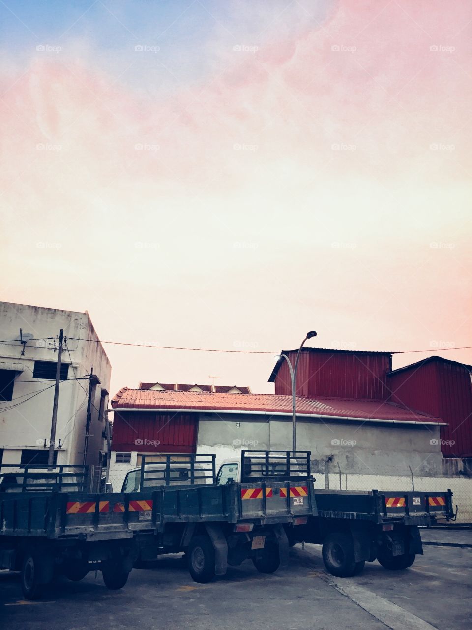 Three trucks parked behind the shop lots in Penang island malaysia.