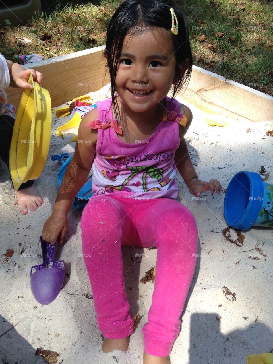 Girl smiling in the sandbox