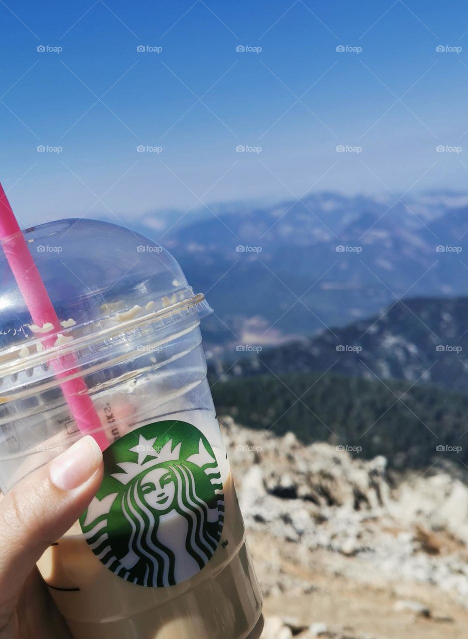 Cup of starbucks in the mountains