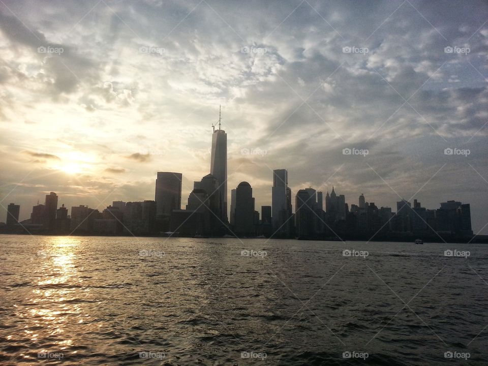 new York city skyline in the morning just after sunrise with a cloudy sky