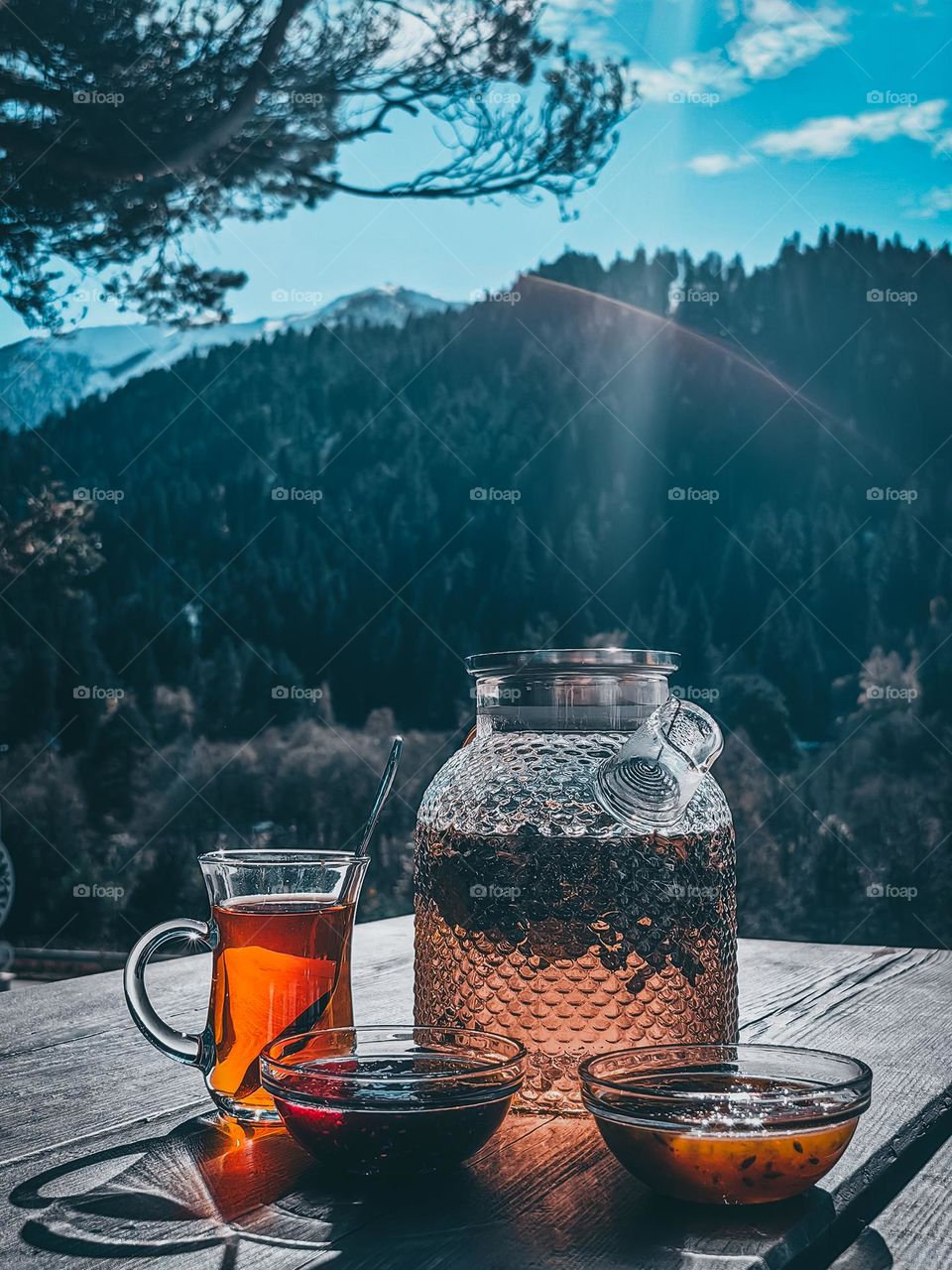 Teapot with tea on the background of mountains