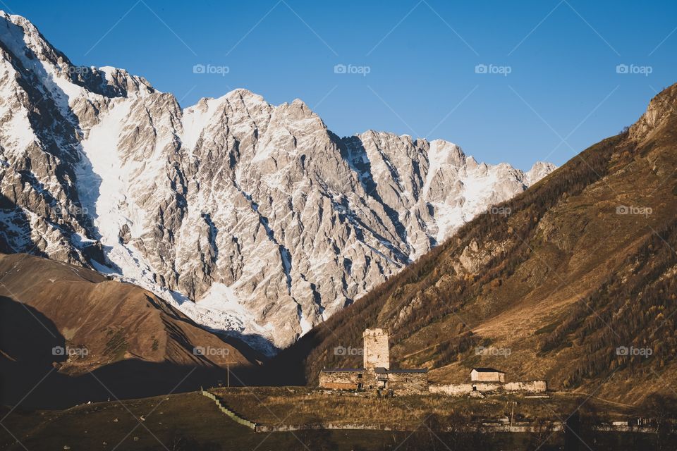 Day scene of church and cross at Ushguli Georgia