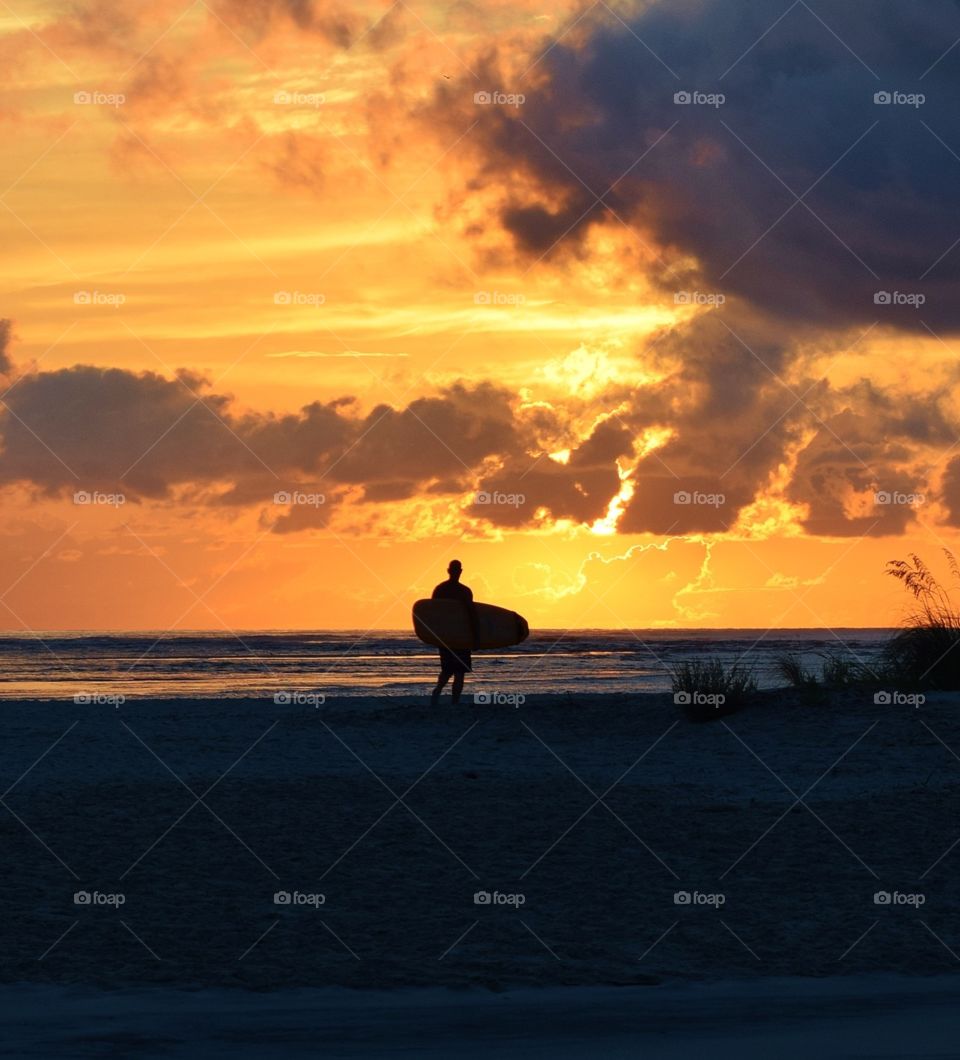 Surfer on the beach at Saint Simons Island Georgia ready to catch the first wave. 