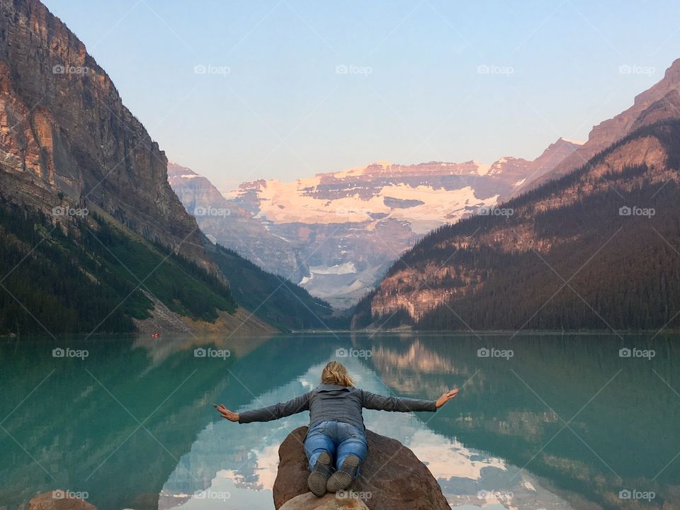 If I could go on the journey with the lake I would....
Endless summer at lake Louise in beautiful Rocky Mountains Banff National Park, Alberta Canada. Woman pretending to fly over lake