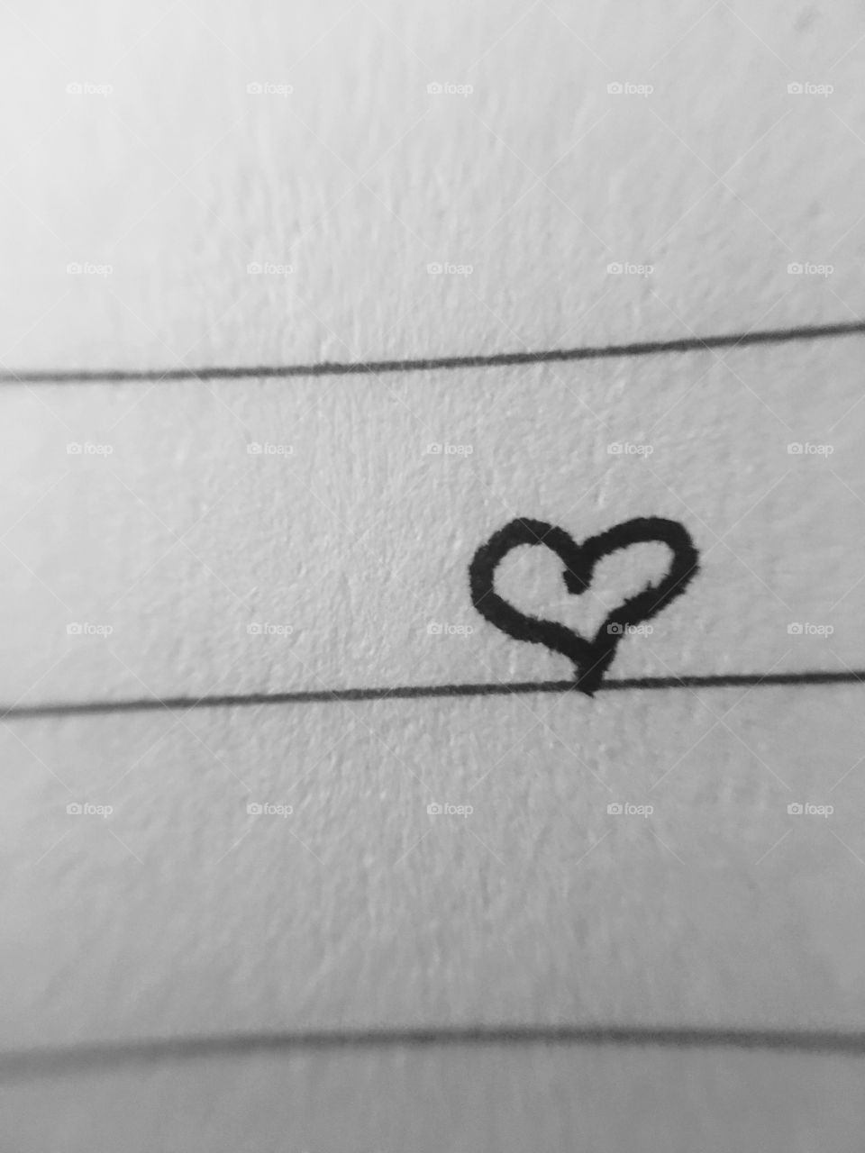 Heart drawn on paper. Micro-lens. 