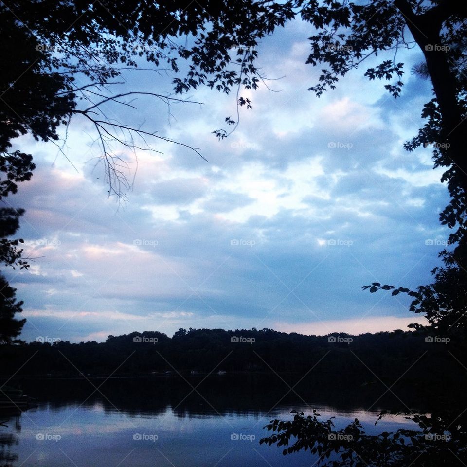 Lake sunset framed by trees