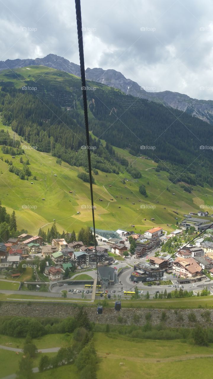 Blick aus der Gondel der Bergbahn auf das Dorf im Tal