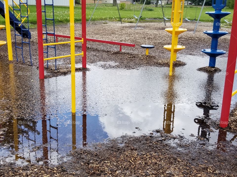 This playground was flooded so no one could play.  But the reflection of the clouds in the water cheers me up.