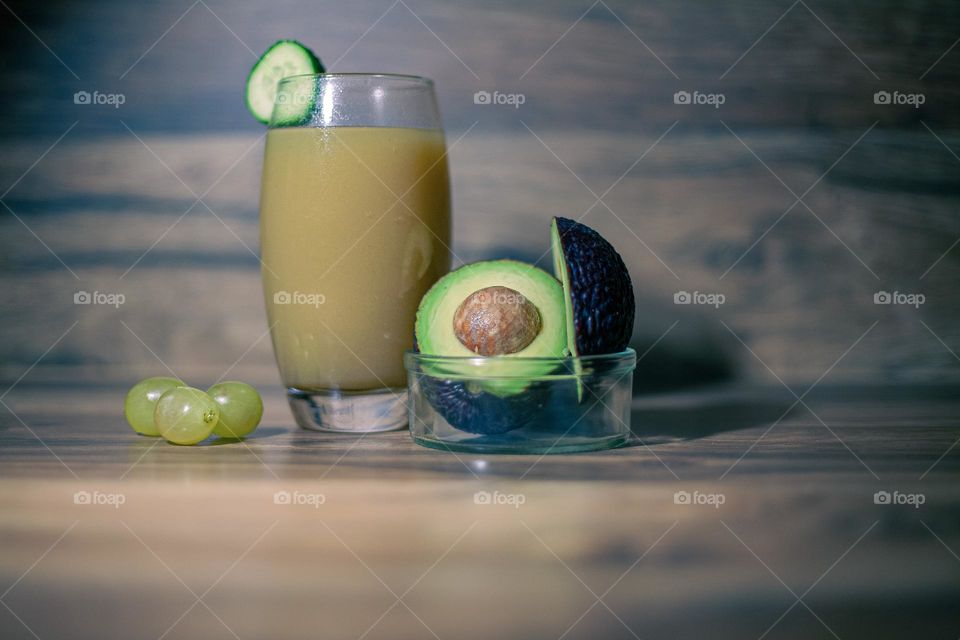 Healthy juice with avocado and three grapes 