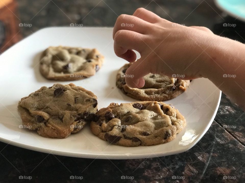 Reaching out for a Chocolate chip cookie 