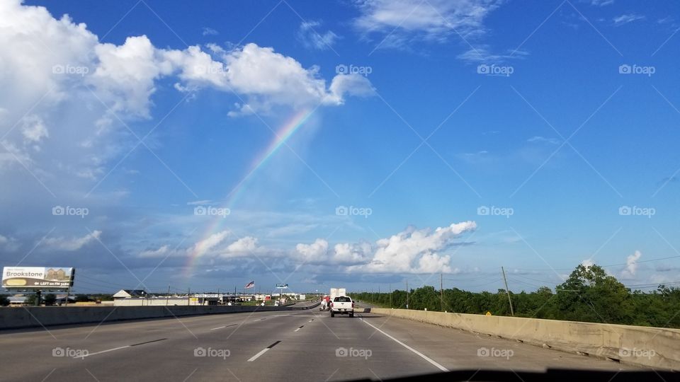 Rainbow above a Texas highway.