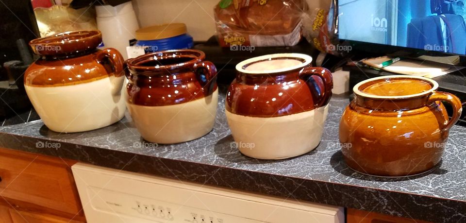Row of several antiques. Old bean pot crocks, these are traditionally the colors they were made, they fired in kilns many years ago.🍯