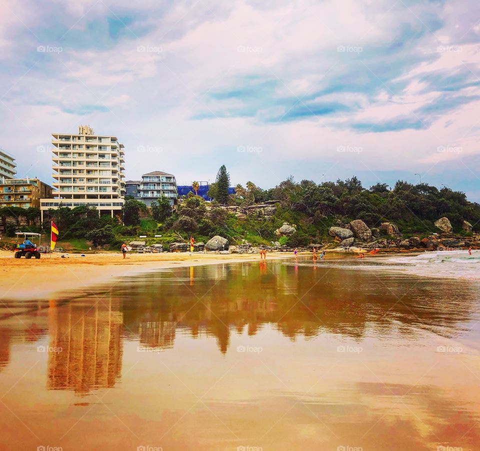 Reflections in the wet sand - beach apartments 