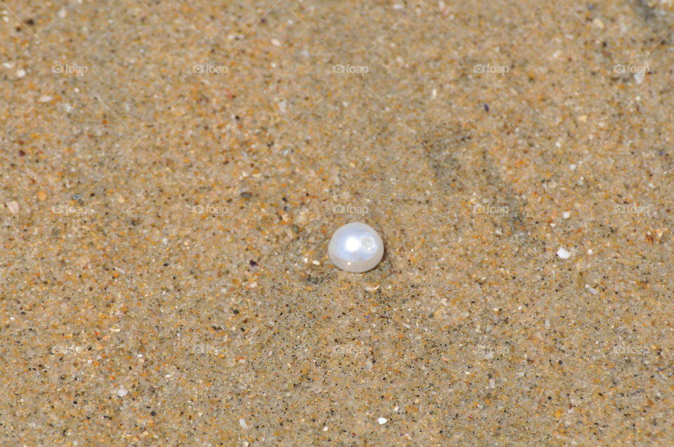 Pearl on the beach sand